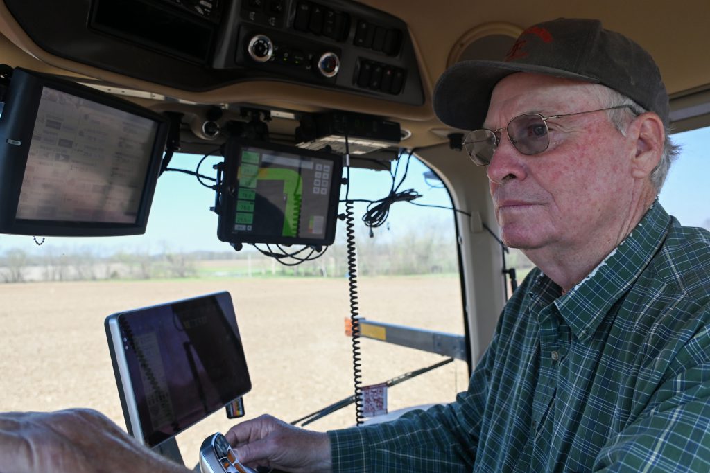 Frank Glenn operates a tractor while planting corn on April 11, 2023 at Glendale Farm and Stables in Columbia, Mo. The multiple screens monitor the mechanics of the tractor and where the corn has been planted. Photo by Maya Bell