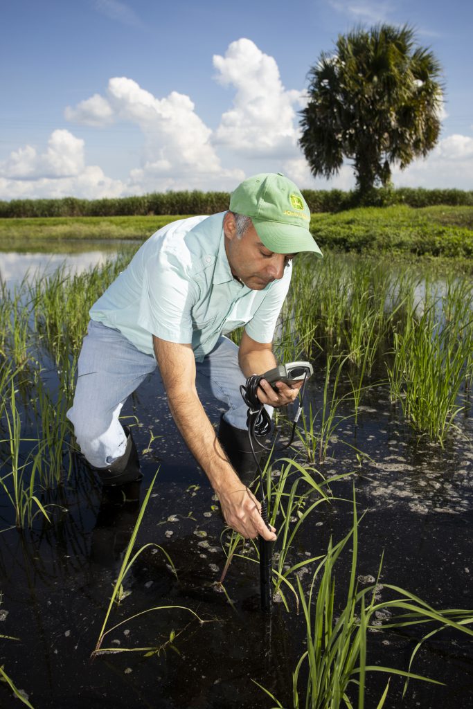Bhada conducts water quality monitoring in a flooded rice field at the Everglades Research and Education Center in Belle Glade, Florida. (Courtesy of Jehangir Bhada)