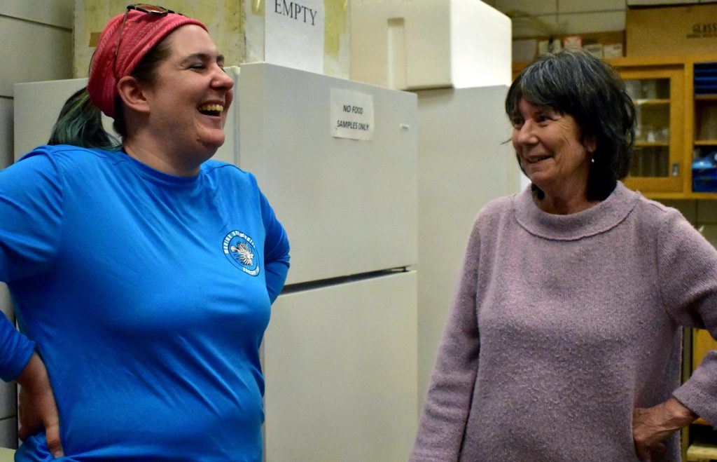 Cassandra Glaspie and Nancy Rabalais share a laugh in a LUMCON lab in Cocodrie, La., Wednesday, March 15. (Lauren Whiddon/WUFT News)