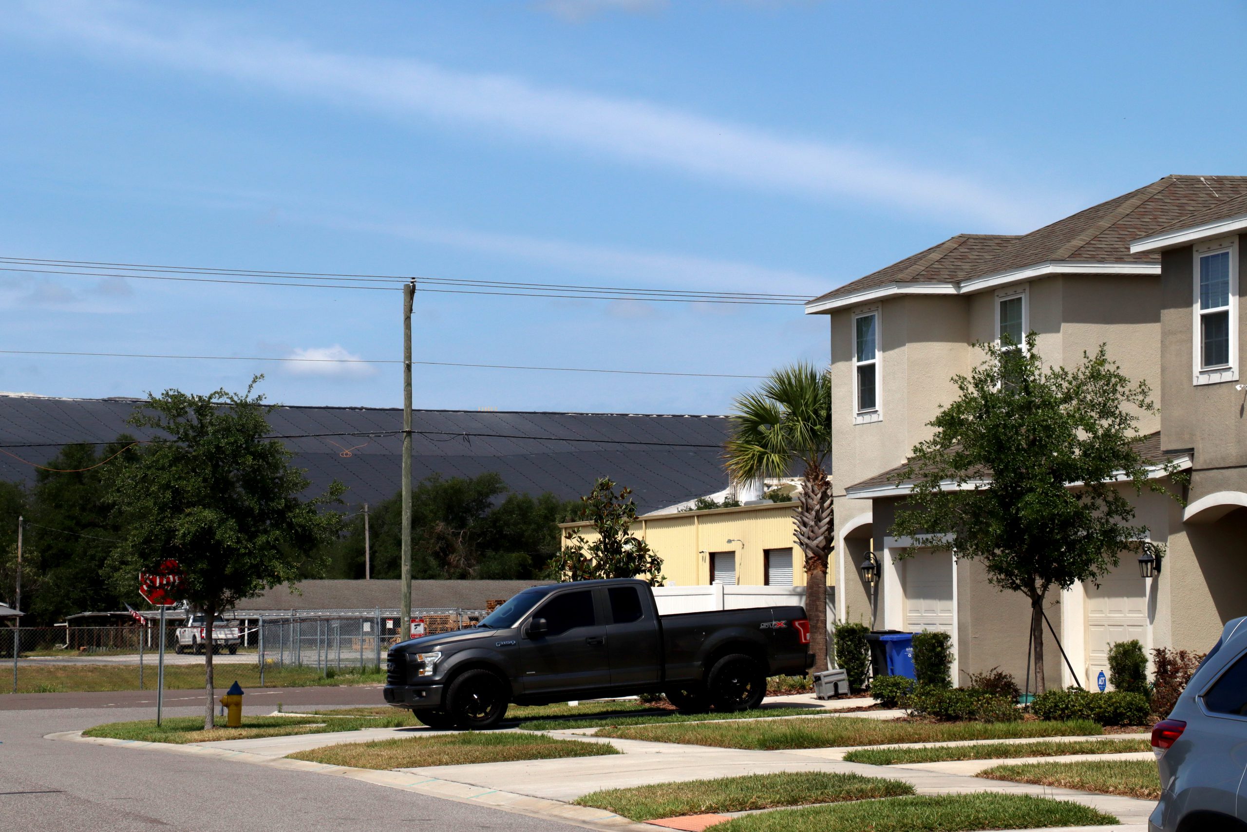 A community of recently built townhomes a few hundred feet from a phosphogypsum stack in Riverview, Florida, Friday, April 14, 2023. (Alan Halaly/WUFT News)