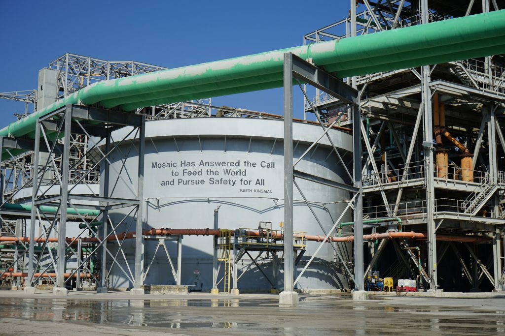 A sign that reads “Mosaic Has Answered the Call to Feed the World and Pursue Safety for All” at Mosaic Co.’s Four Corners phosphate mine processing facility in South Bradley, Fla. Feb. 23, 2023.