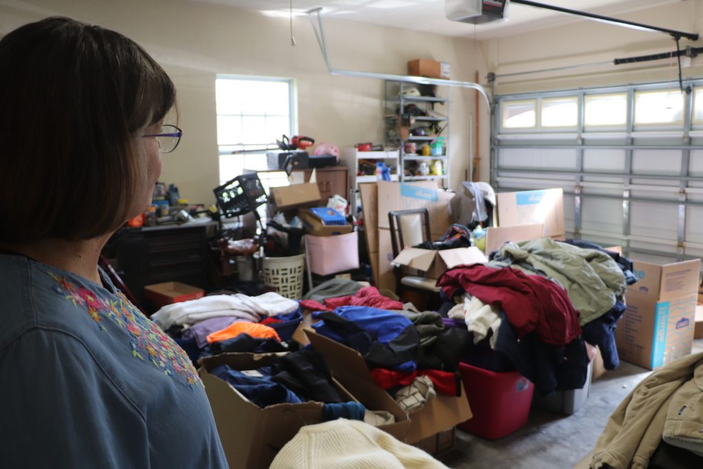 Lyuba Wharton surveys the boxes she and her husband have packed with volunteers. “It will be more difficult for us not to do anything than to do so much as we do,” she said. (Anna Wilder/WUFT News)