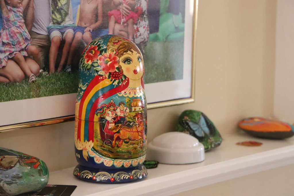 A Matryoshka doll sits on a shelf next to family photos inside the Whartons' home in Gainesville (Anna Wilder/WUFT News)