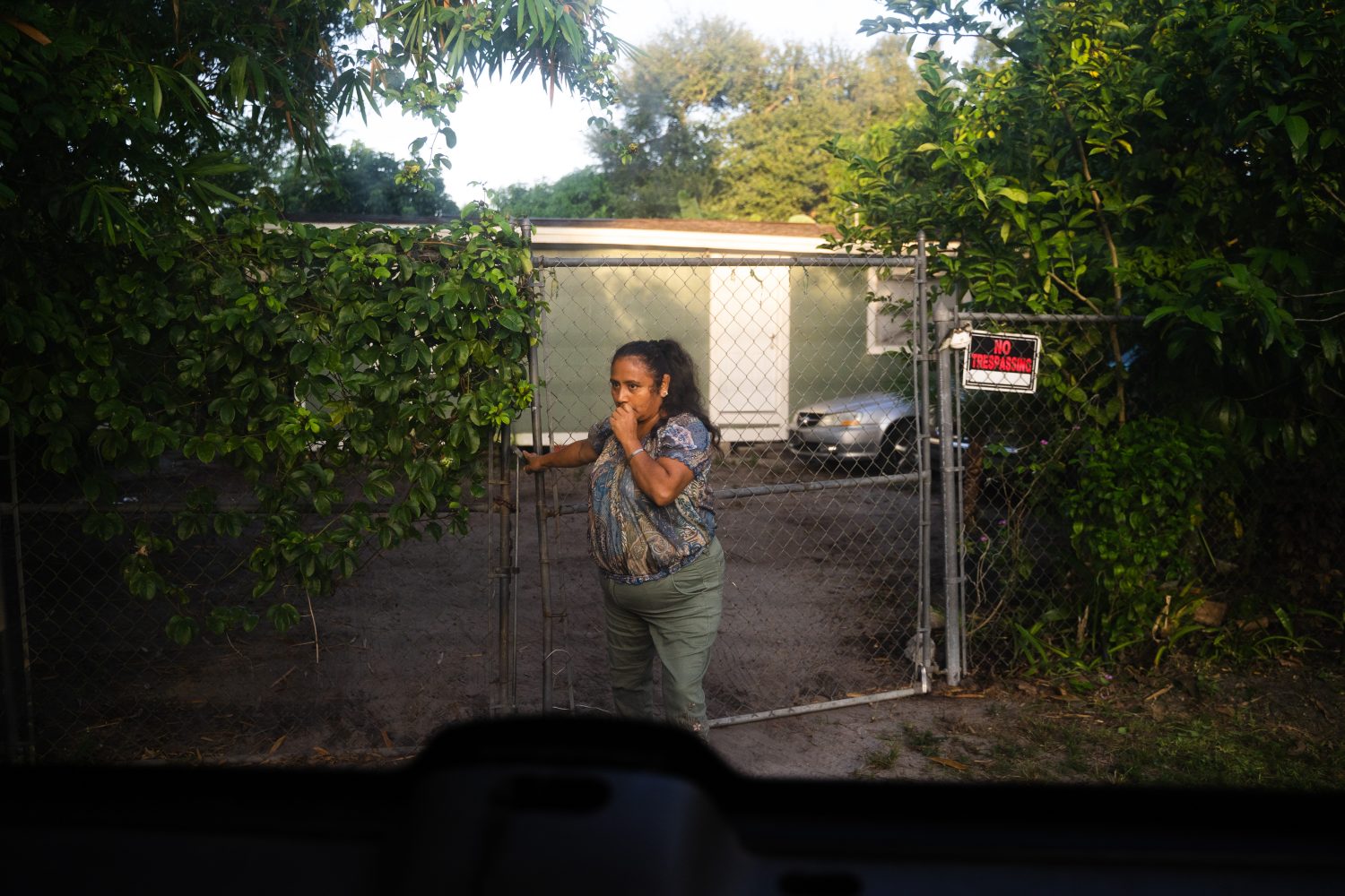 Antonia Rios closes the gate to their home before driving Vanessa to school. She is grateful that the family has its own space. Previously, they lived in trailers alone or with other families, a common practice of migrants workers trying to save money on rent. (Justin Bright/WUFT News)