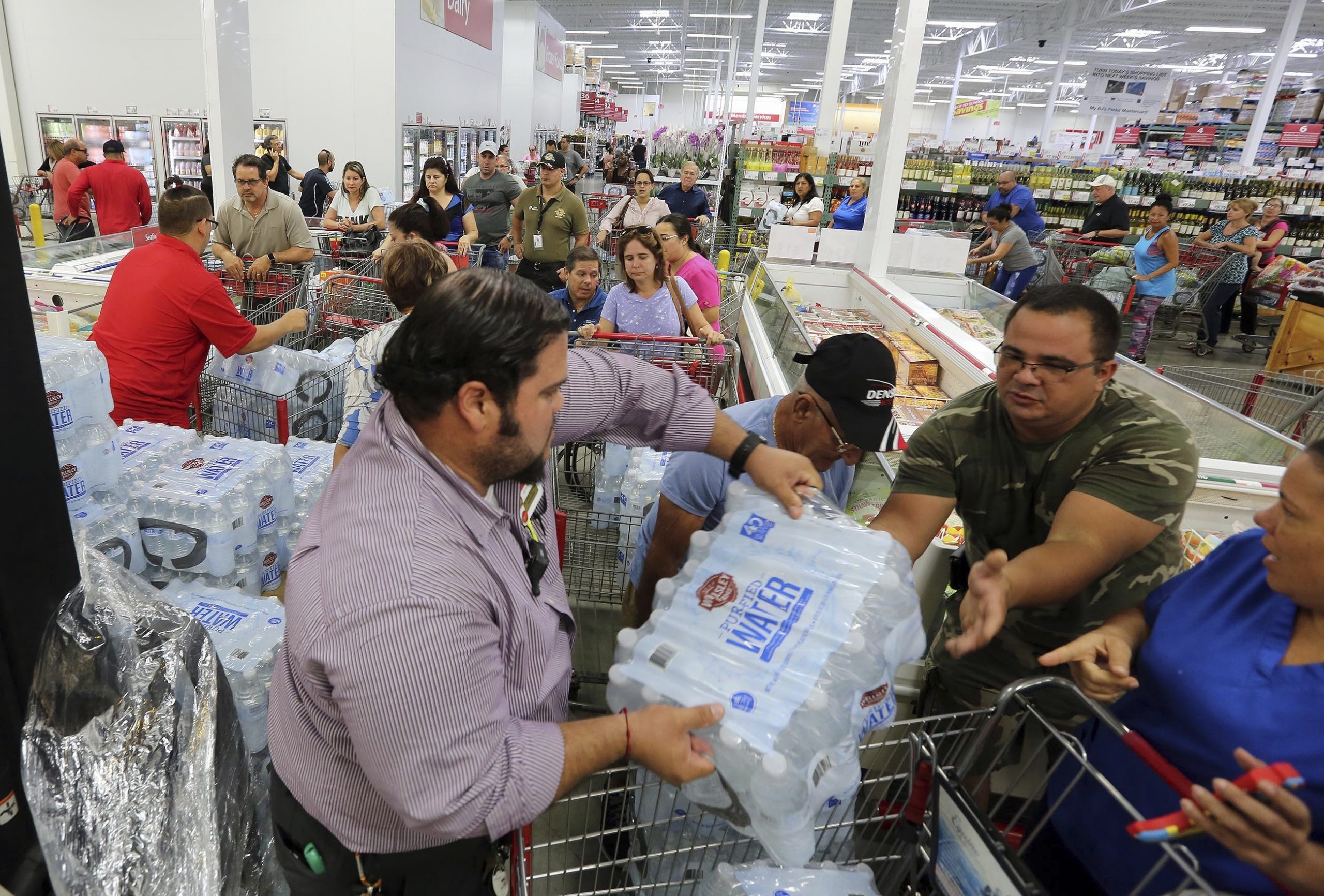 Residents purchase water at BJ Wholesale in preparation for Hurricane Irma Tuesday, Sept. 5, 2017, in Miami. Hurricane Irma grew into a dangerous Category 5 storm, the most powerful seen in the Atlantic in over a decade, and roared toward islands in the northeast Caribbean Tuesday on a path that could eventually take it to the United States. (Roberto Koltun/Miami Herald via AP)