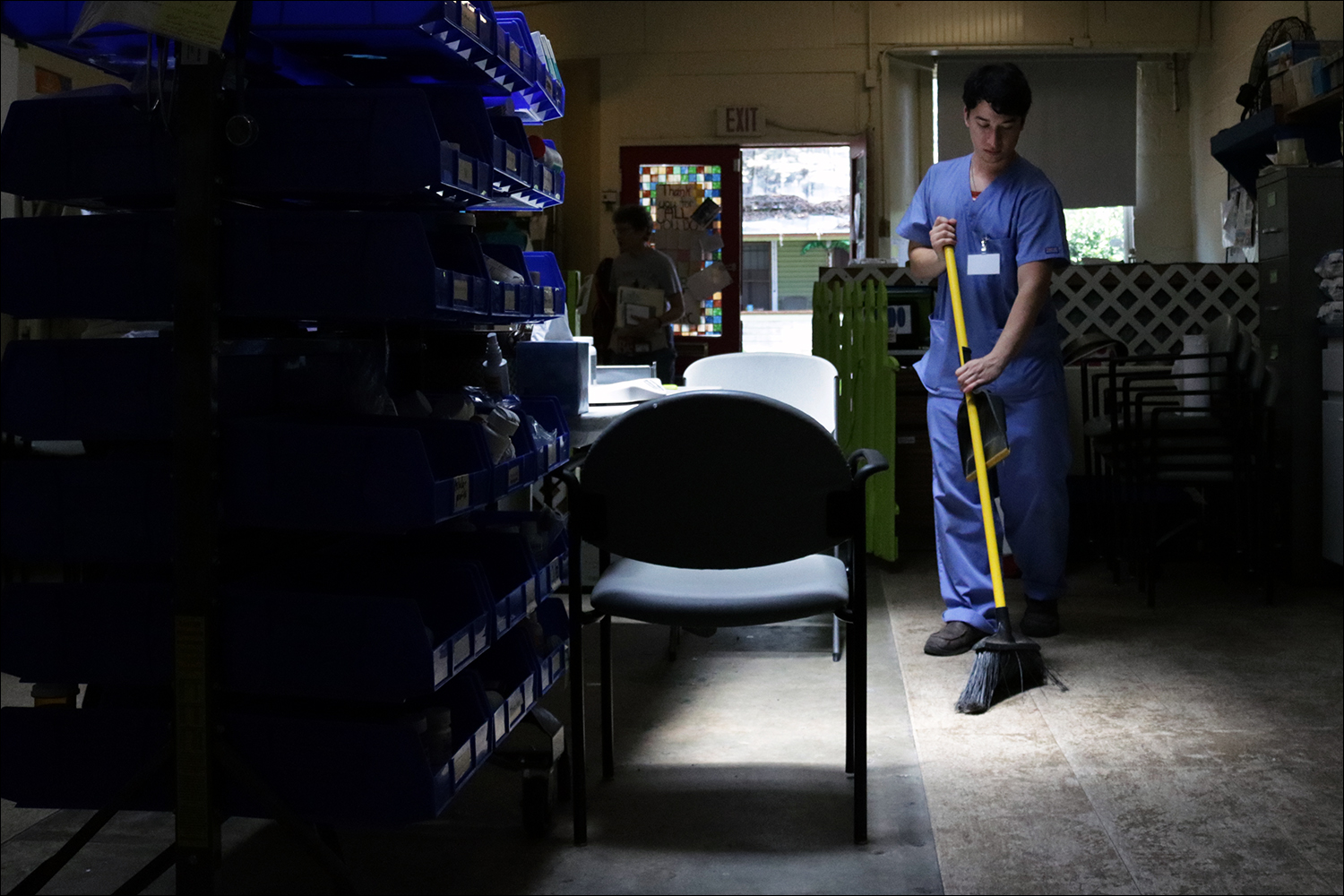 David Rodriguez sweeps the clinic's floor after the last patient left Tuesday, June 19, 2018. The clinic is open for four hours every Tuesday, but many patients show up early to get a place in line and ensure their pets will be able to see a vet. (Kaitlin Hall/WUFT News)