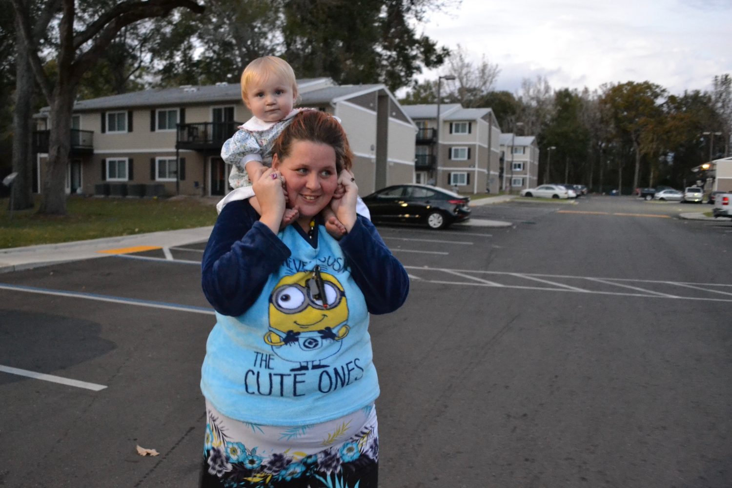 Millie takes baby Sandy on a walk in the apartment complex. "Either she's getting too heavy or I'm getting too old," she joked. (Monica Humphries/WUFT News)