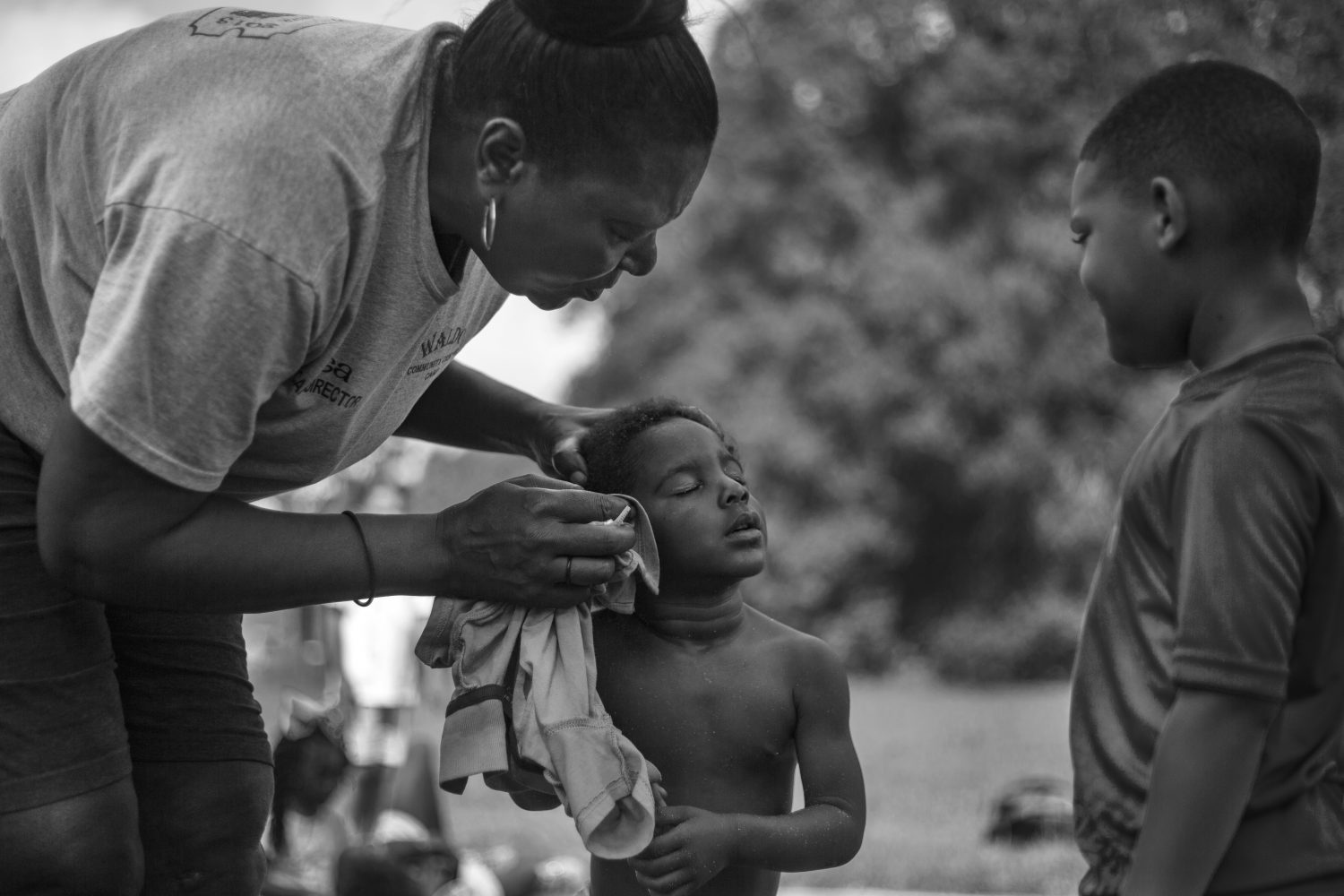 Hill cleans sand off of a child’s face after he fell on the playground. Despite working long days and nights, Hill emphasized being constantly alert around the children. “When I get an award, It is gonna be from the man above,” Hill said.