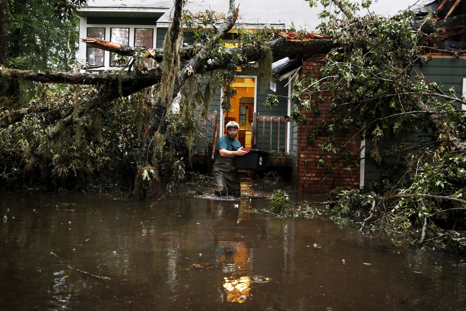 Chris Deacon salvages kitchen essentials from his home following Hurricane Irma's wrath in Gainesville, Fla., Sept. 15, 2017.