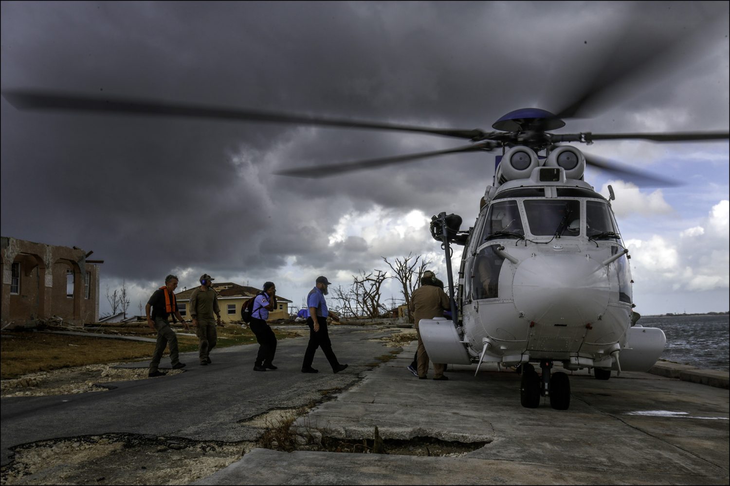 A team sent by the Bahamian government to check on the conditions of clinics around the island leaves from inspecting a destroyed clinic in McLean’s Town, Grand Bahama