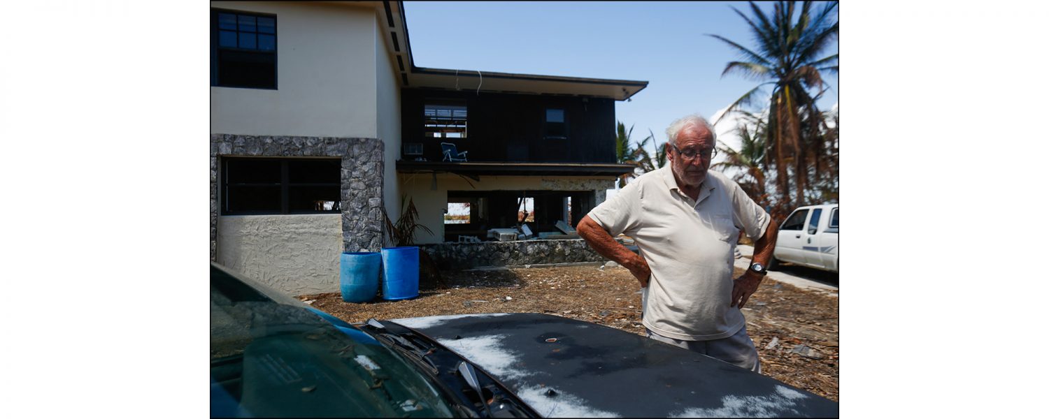 David Copperthwaite looks down at the ground after taking a break from gathering belongings from his home in the neighborhood of Queen's Cove in Freeport, Grand Bahama on Sept. 17, 2019. Copperthwaite lives in Florida and his son Steve rode out the storm in the home. Steve Copperthwaite said the flood water was about two feet over the 10-foot-high ceiling of the home, which is built four feet above sea level.