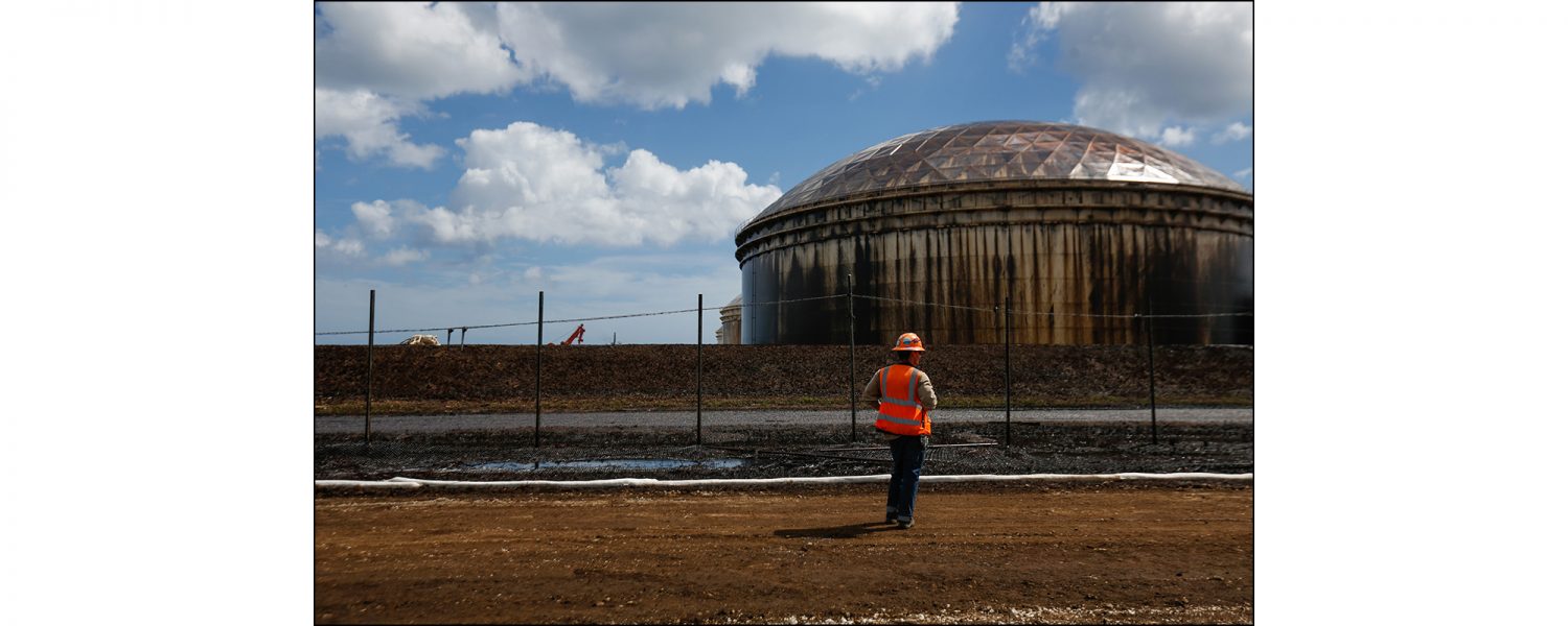 A worker inspects a storage tank at the South Riding Point facility in Grand Bahama on Sept. 16, 2019. Equinor, the company that owns the facility, released a statement on Sept. 5 acknowledging the terminal took damage and that oil has spilled from multiple tanks and that a the company is organizing clean-up efforts.