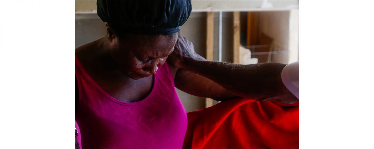 Remelda Thomas bows her head in prayer within her home in McLean's Town Grand Bahama on Sept. 16, 2019. Thomas said she lost eight family members in the storm. While sleeping one night after the storm the wind was blowing and the tarp over the hole in her roof was snapping and it brought back the fear from Hurricane Dorian. "Oh God this hurricane is back," she said she thought that night.