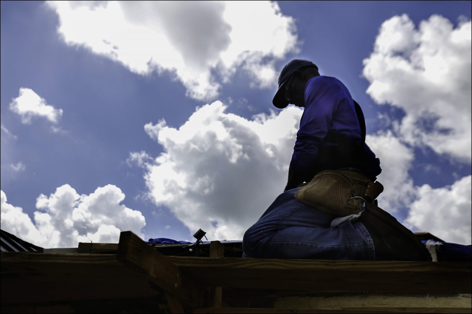 Pastor Cecil Kemp looks at his tools while starting repairs on the roof of his home in High Rock, Grand Bahama on Sept. 16, 2019. On the road where Kemp lives, Solomon Drive, only four houses remain occupied and 17 people from the community died in the storm, he said. "I'm a leader here and I plan to help rebuild this community back." Despite the losses, Kemp said he believes God has been good to him and protected his church, Lighthouse Chapel, from the storm. "If you see where it's located right next to the ocean there is no way it stands," he said.