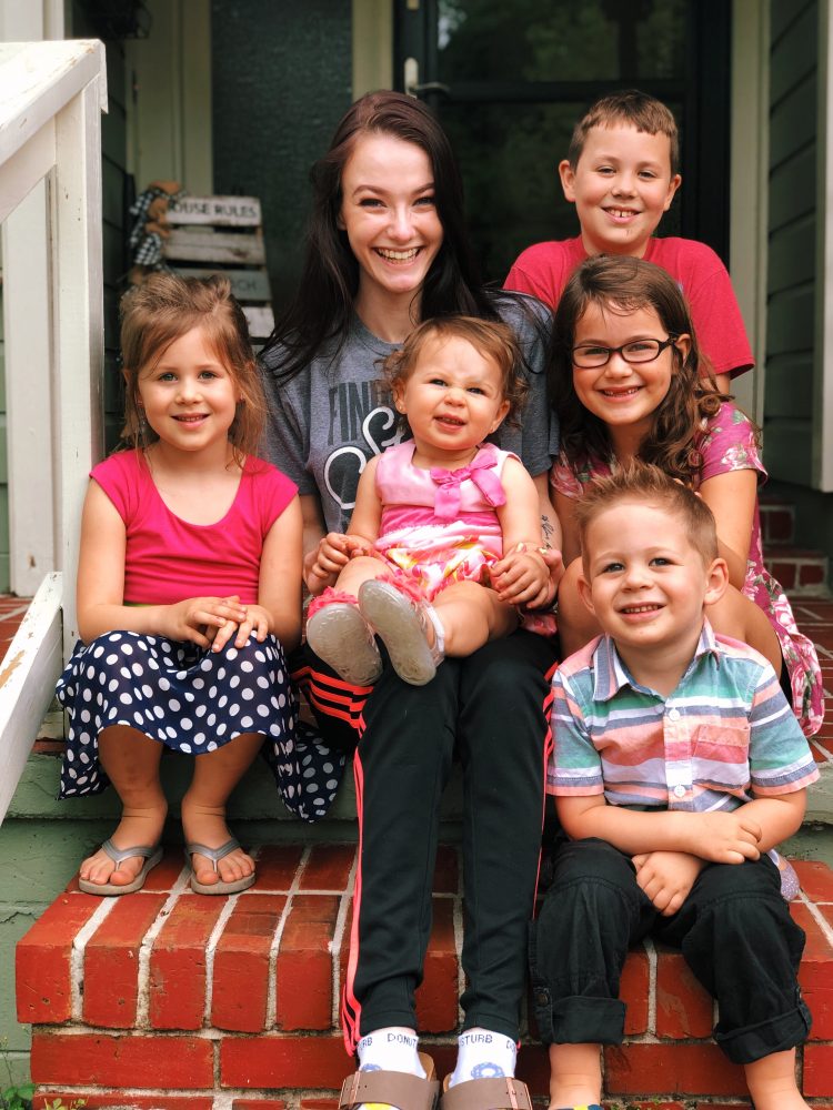 Benefield hugs the children she babysits. Her "kiddos," she says, are the lights of her life.
