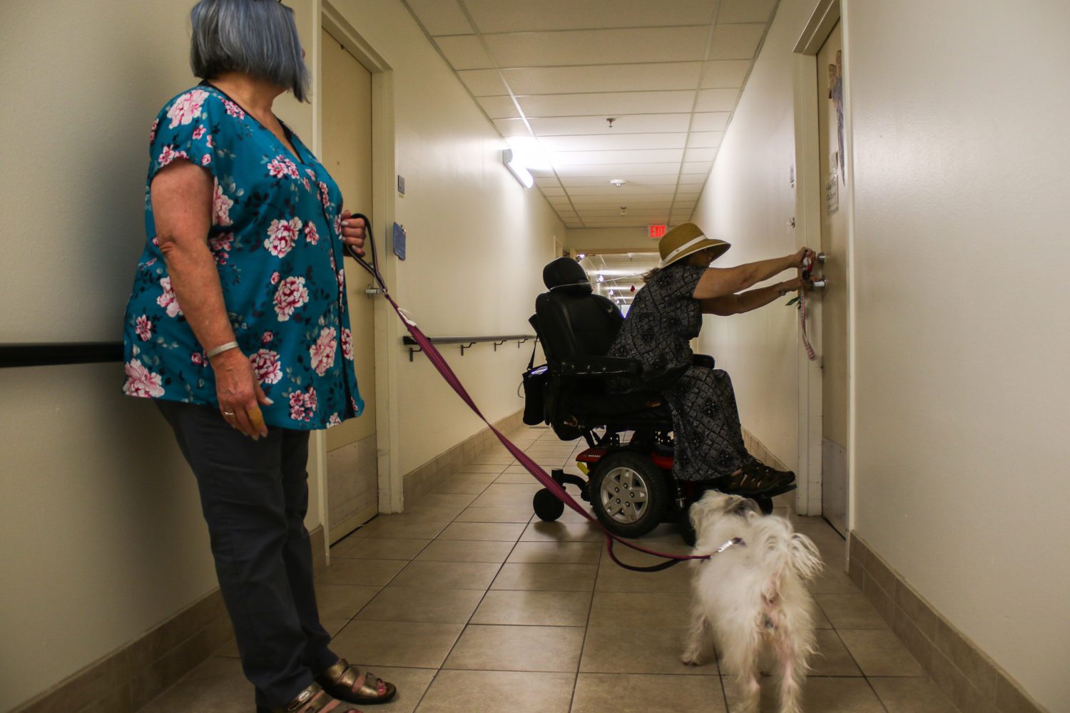 Carole locks the door to her apartment while her sister, Mary Park-Smith, waits for her with Carole's dog Kiki. Mary visits Carole every Monday and normally walks Kiki with her around the apartment complex. Carole moved to Gainesville from Maryville, Tennessee to be closer to Mary in 2015. Mary takes Carole to get groceries and pick up her medication most weeks.