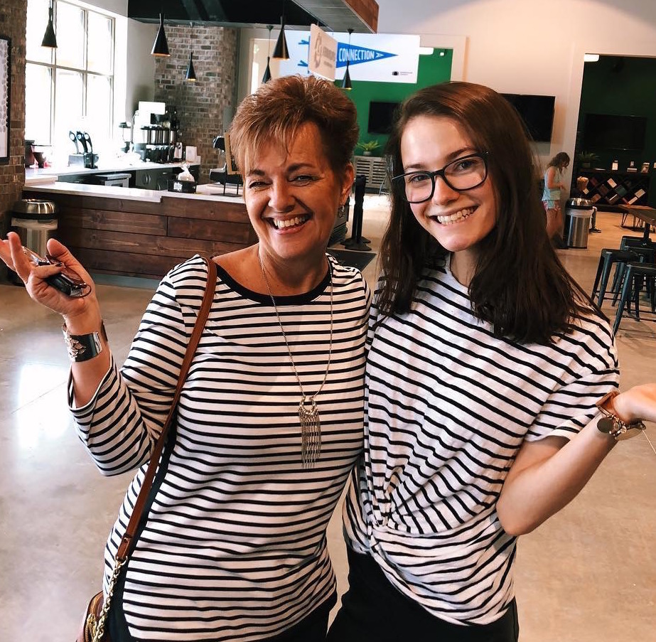 Benefield and her mom, Joyce, pose in matching shirts inside the lobby of Greenhouse Church in Gainesville, FL. Her church community, Benefield says, helped her in her darkest days.