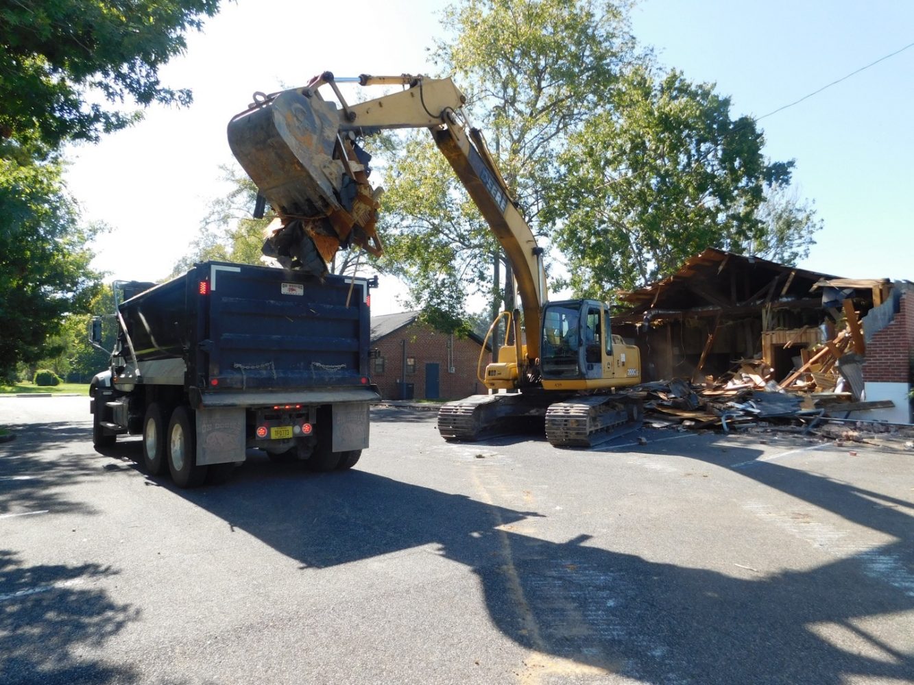 The whole town quakes as men in blue polos climb in and out of dump trucks and bacos, wrecking earthquake sized holes in the dilapidated senior center with ease. (Emma Witmer/WUFT News)