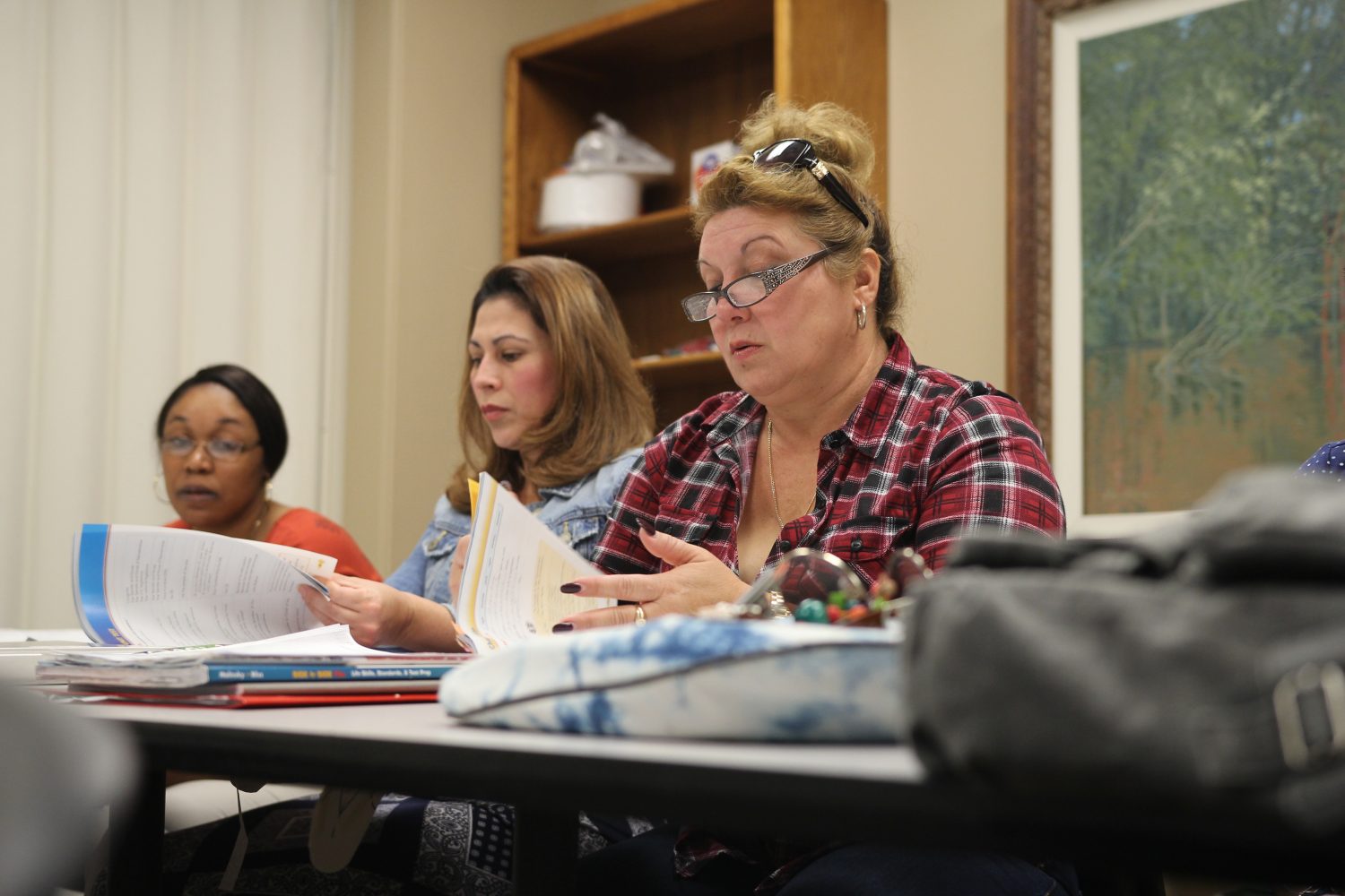 Students flip through the citizenship test prep textbook. The group meets at the Marion County Literacy Center every week. (Gabrielle Calise/WUFT News)