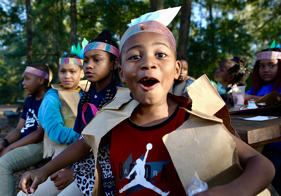 Mar'Quise, a student at Kids Count, celebrates Thanksgiving with a handmade Native American headdress. (Emma Green/WUFT News)