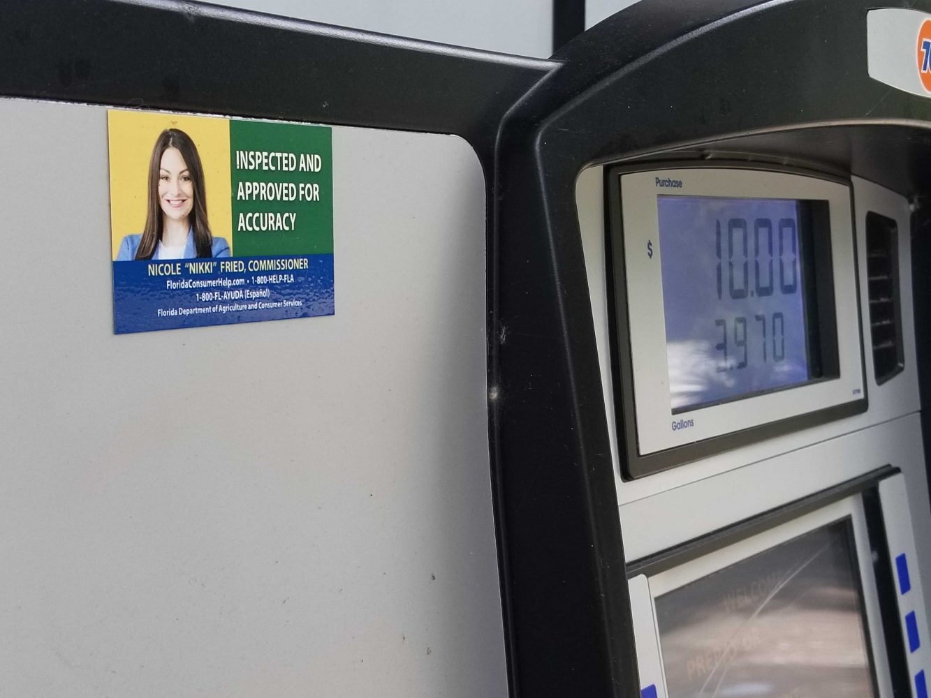 A Florida Department of Agriculture inspection sticker on a Gainesville gas station pump displays Commissioner Nikki Fried's face. (Matthew Serna/WUFT News)