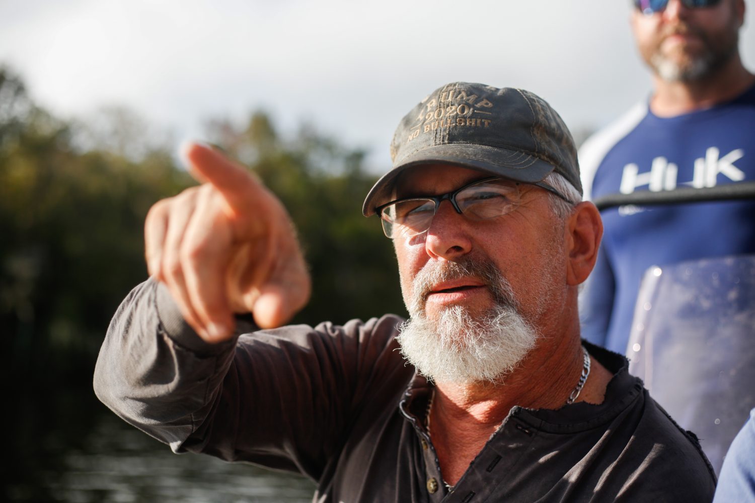 Richie Smith directs Alex Horton towards where he thinks they may find alligators while hunting on October 26, 2019. (Chris Day/Fresh Take Florida)