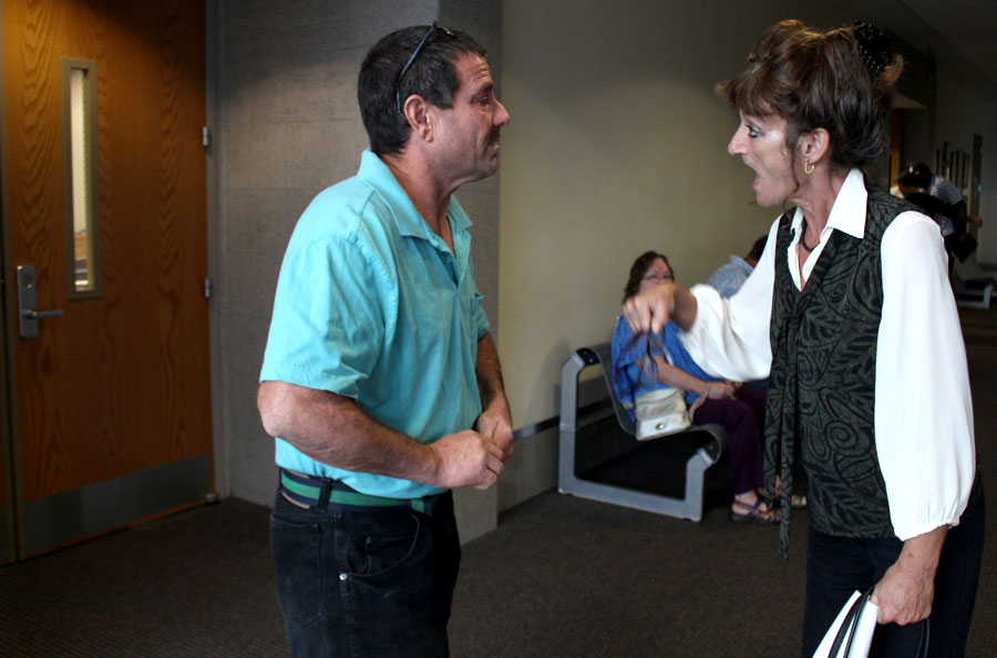 Outside the courtroom, Becky argues with Johnny about her case.