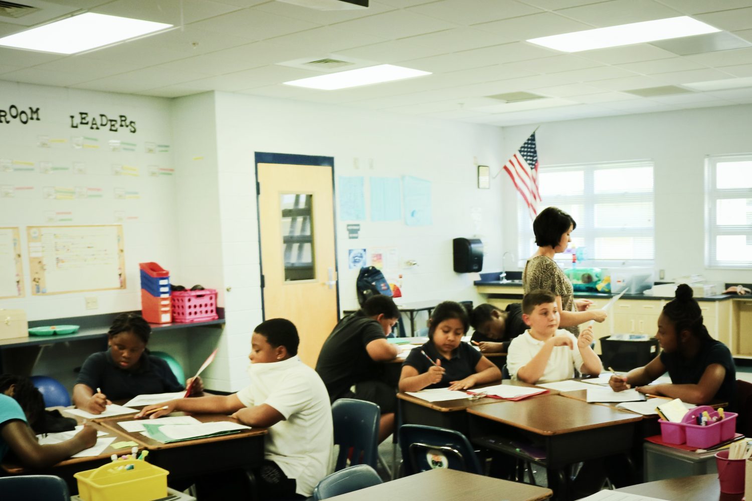Peebles surveys the classroom as her students work on a group assignment. No matter what the problem, she is there to help them all.